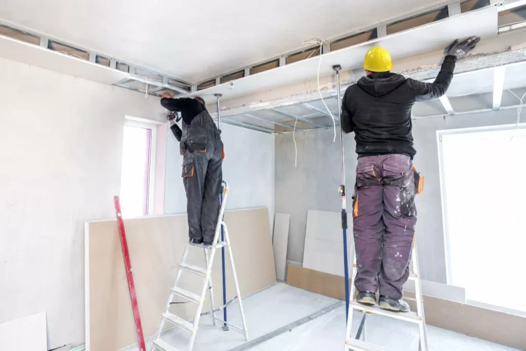 Professional drywall repair and ceiling restoration team working on a home in Surrey.
